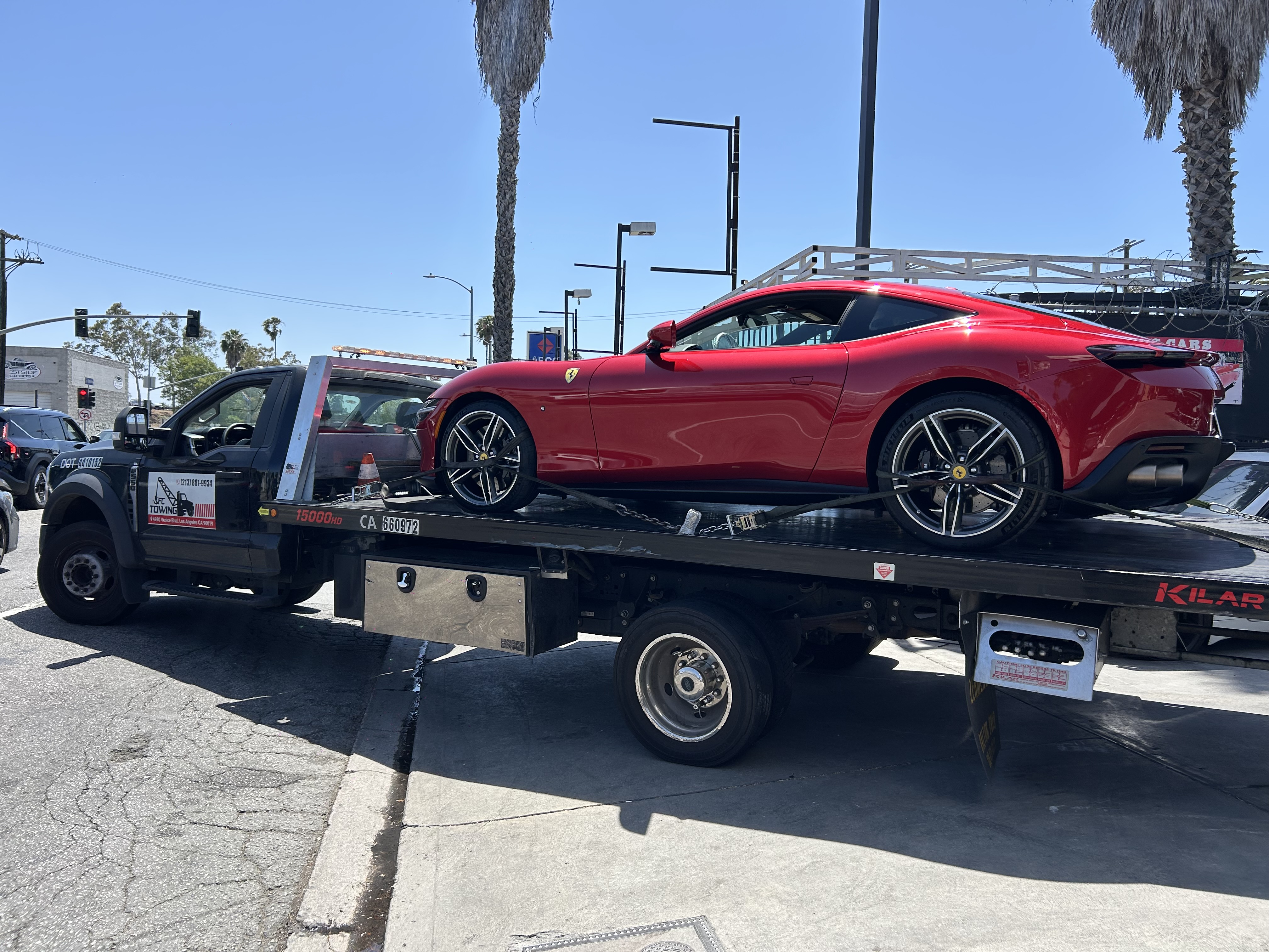 Tow truck delivering a damaged vehicle to Mac Auto Collision
